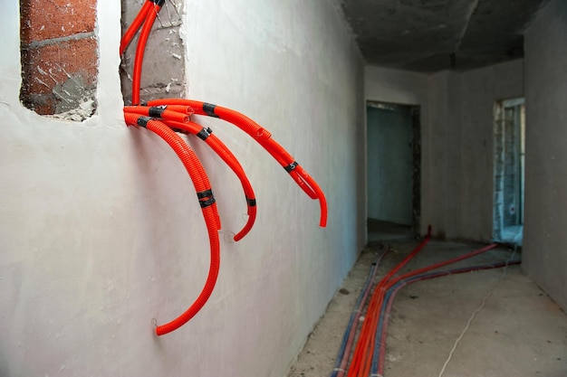 orange plastic heating pipes in a building under construction Installation of underfloor heating