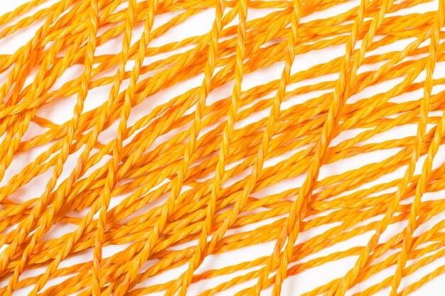 Orange plastic ropes on a white background