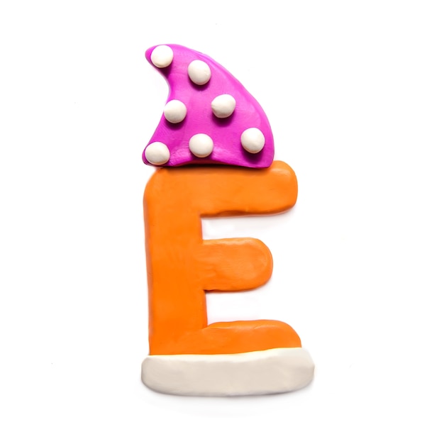 Orange plasticine letter E of the alphabet in a winter pink cap on a white background