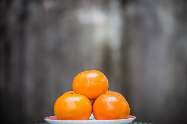 Orange in plate with gray background