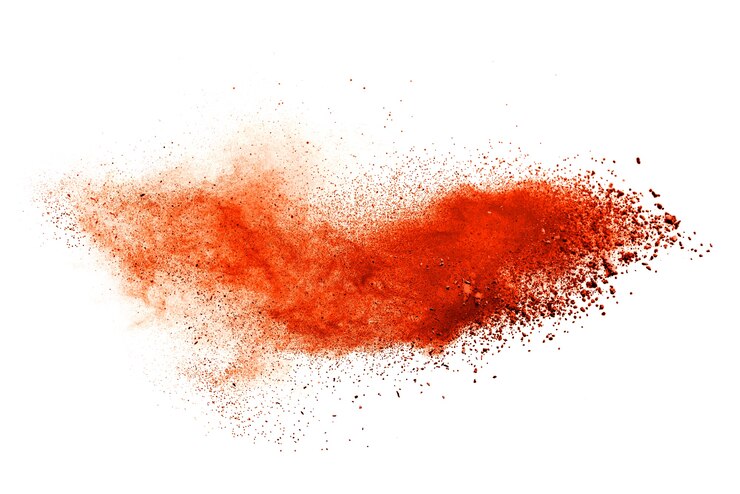 Photo orange powder explosion isolated on white  background