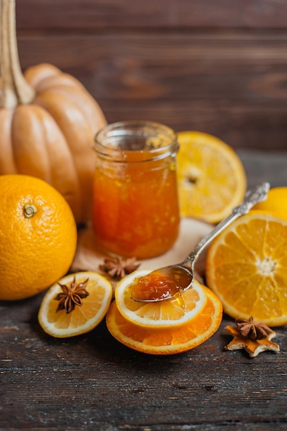 Orange pumpkin and ginger jam on a wooden background