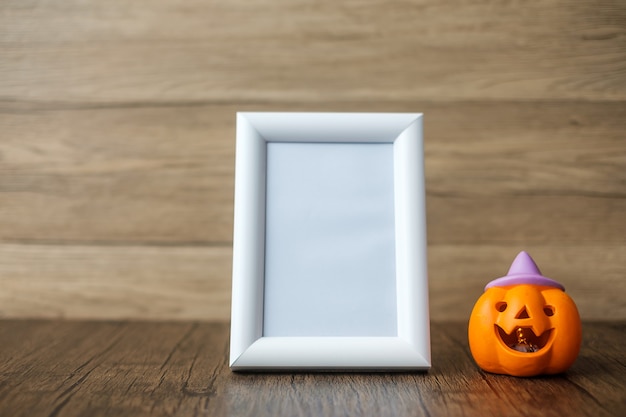 Orange pumpkin on table and frame with copy space for text. Happy Halloween day, Hello October, fall autumn season, Festive, party and holiday concept