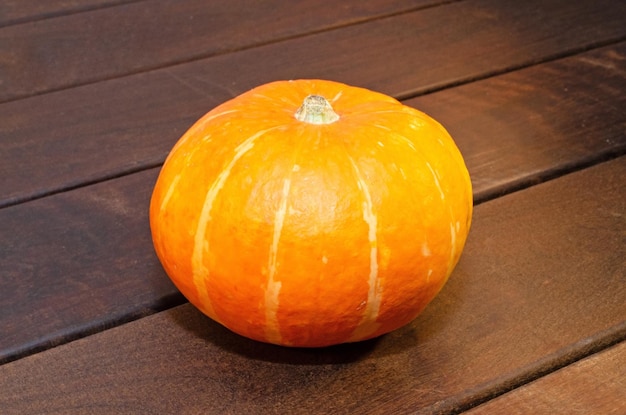 Orange pumpkin on a wooden table