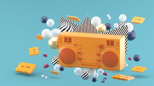 Orange radio amidst colorful balls on blue. 3d render
