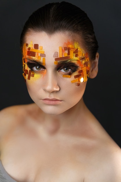 Orange and Red Rhinestones on a Girl Face