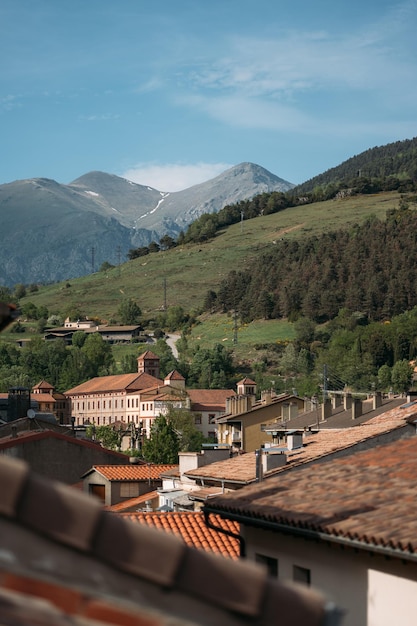 Orange roofs of modern houses in small village of ribes de freser at foot of pyrenees in spain