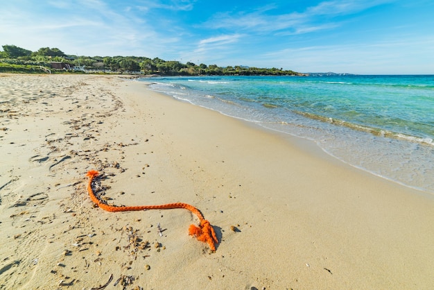 Orange rope in Rena Bianca beach Sardinia