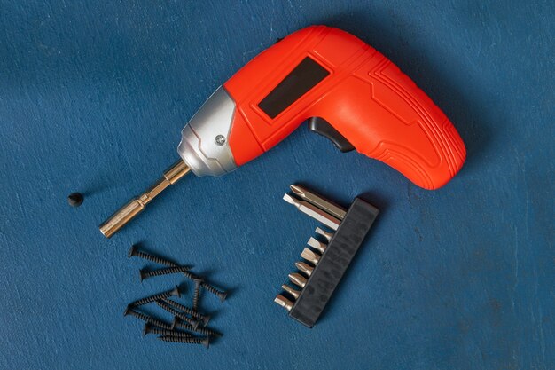 Orange screwdriver, screws, a set of bits