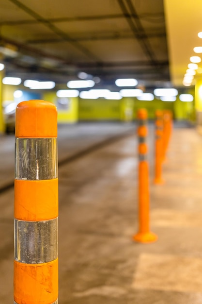 Orange security bollard in underground parking