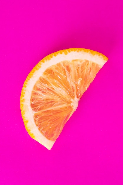 Orange slice isolated, pink background