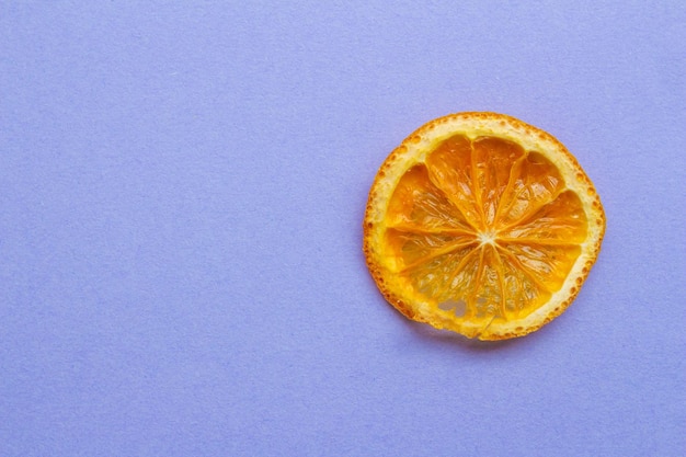 An orange slice on a purple background