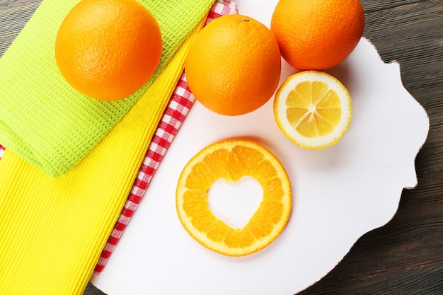 Orange slice with cut in shape of heart on table close up