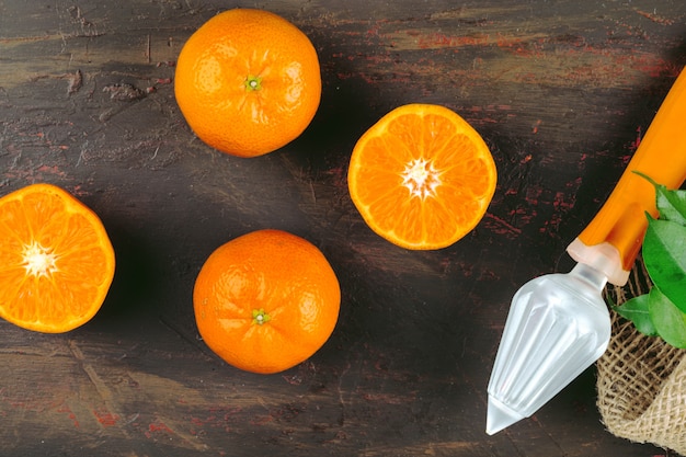 Orange sliced into pieces and orange juicer