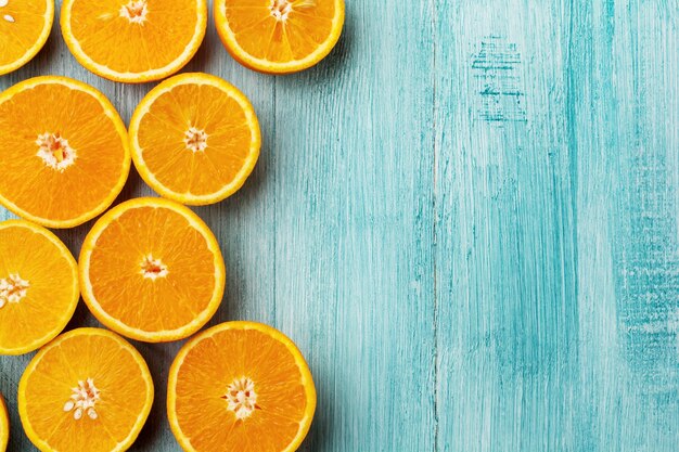 Orange slices flat lay on rustic blue wooden