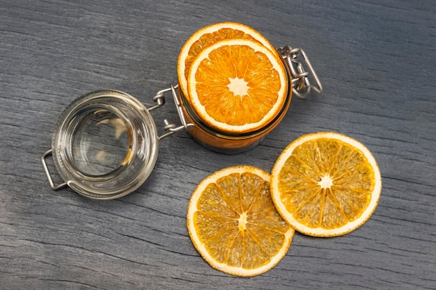 Orange slices in a glass jar and on the table Flat lay