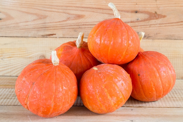 orange small pumpkin on wood table background