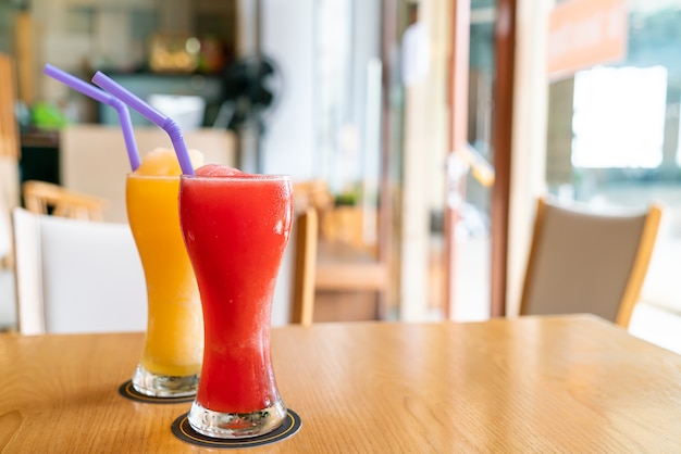 orange smoothie and watermelon smoothie glass in cafe