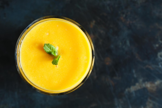 Orange smoothie with mint in the glass top view