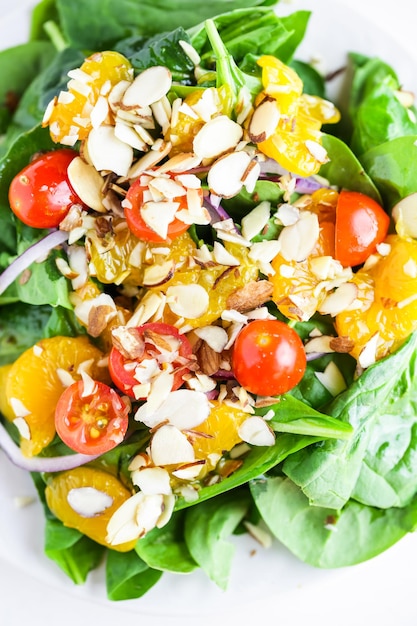 Orange spinach salad on the plate in italian restaurant