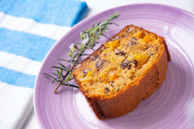 Orange sponge cake with nuts and candied fruit.