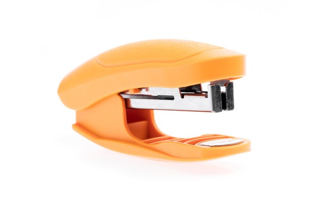 Photo orange stapler isolated on white background