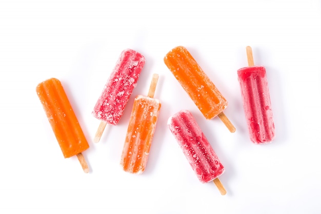 Orange and strawberry popsicles pattern isolated on white