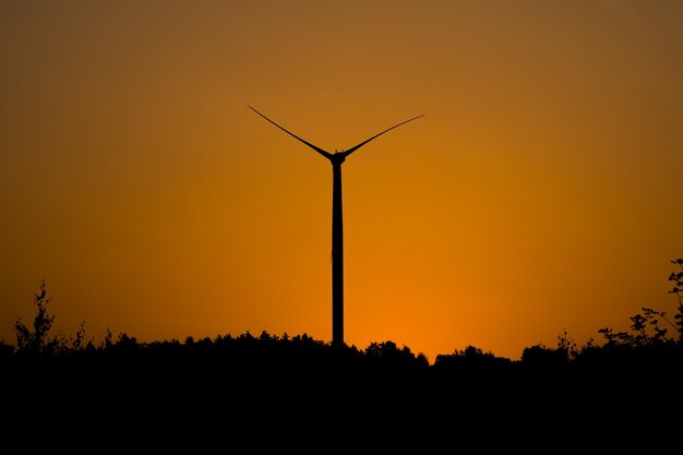 Orange sunrise and wind turbine