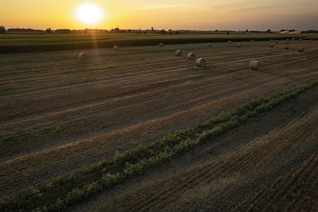 Orange Sunset over Countryside Hayfield