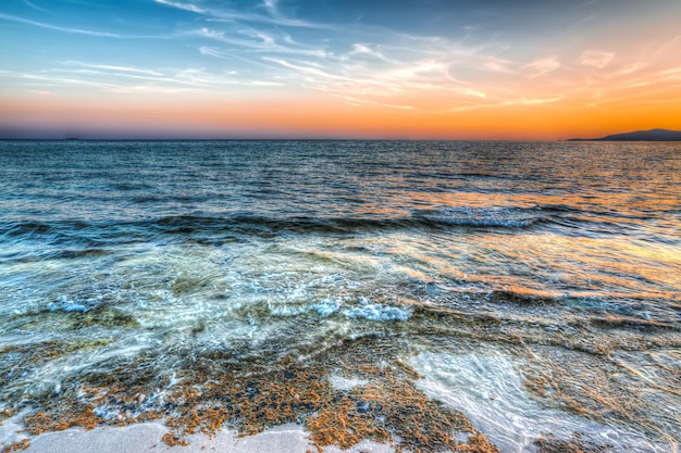 Orange sunset in Maria Pia beach Alghero Shot in Sardinia Italy