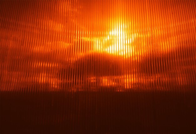 Orange sunset through plastic vertical blinds