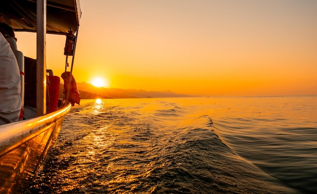 Orange sunset waterside view of shkoder lake in shiroka from a tourist boat albania