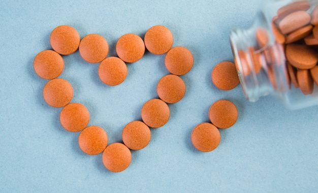 The orange tablets are arranged in the shape of a heart