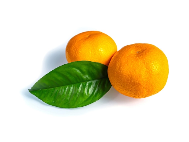 Orange tangerine with green leaves on a white background