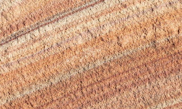 天然天然石の赤い縞とオレンジ色のテクスチャ。砂岩。デザインの背景。