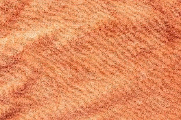 オレンジ色のタオル生地のテクスチャ表面を背景を閉じる