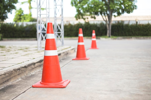 Orange traffic cones on cement road surface