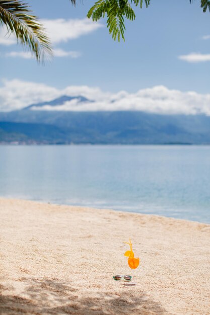 Orange tropical cocktail on beach. sea view.