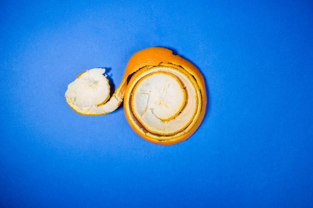 Orange twisted peel on a blue background