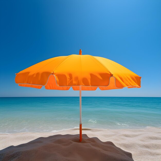 An orange umbrella is on a beach with the ocean in the background