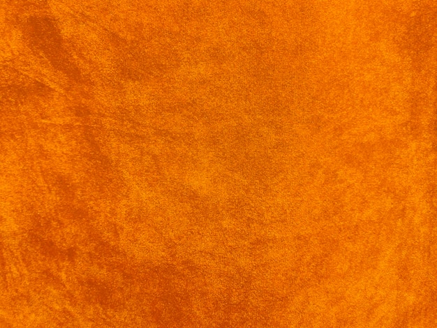 背景として使用されるオレンジ色のベルベット生地のテクスチャ柔らかく滑らかな繊維素材の空のオレンジ色の生地の背景テキストx9用のスペースがあります
