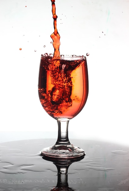 Orange water splash in wine glass