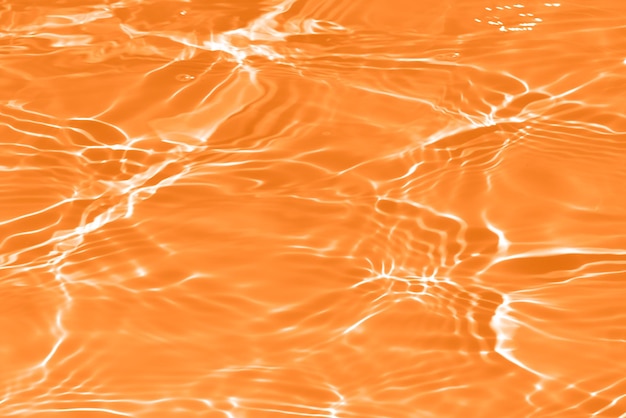 Orange water with ripples on the surface Defocus blurred transparent yellow colore clear calm water