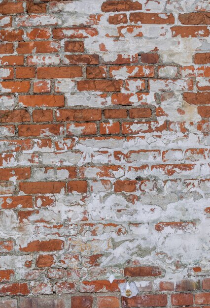 orange wheathered brick wall with snow