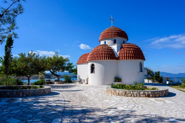 Orange and white church on hills of Nea Roda village and port in Halkidiki, Greece