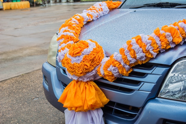 Orange and white curtains Made flowers tied to the car.