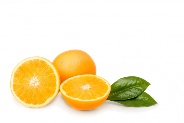 Orange whole and cut into halves with leaves. Isolated on a white background.