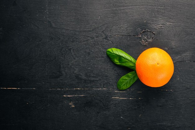 Orange on a wooden background Top view Free space for text