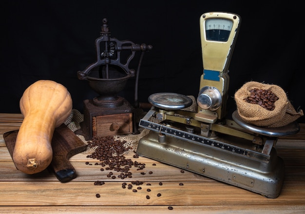 Oranges, bananas, a pumpkin and old accessories on wood