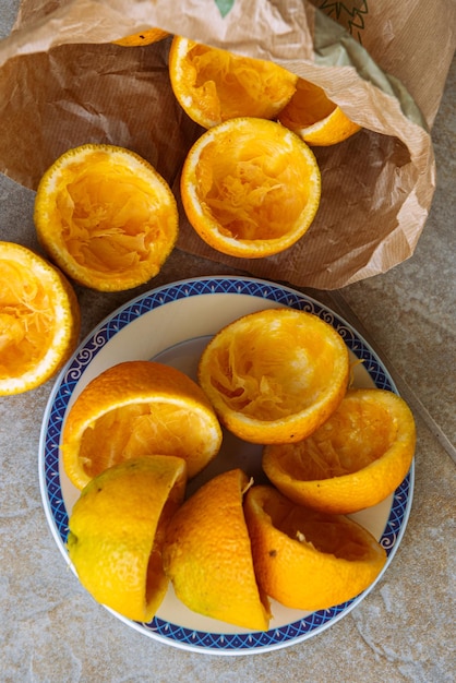 Oranges being squeezed for fresh orange juice and paper bag